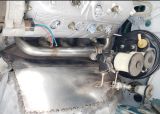 Driver_side_exhaust_header_and_brake_master_booster2.jpg